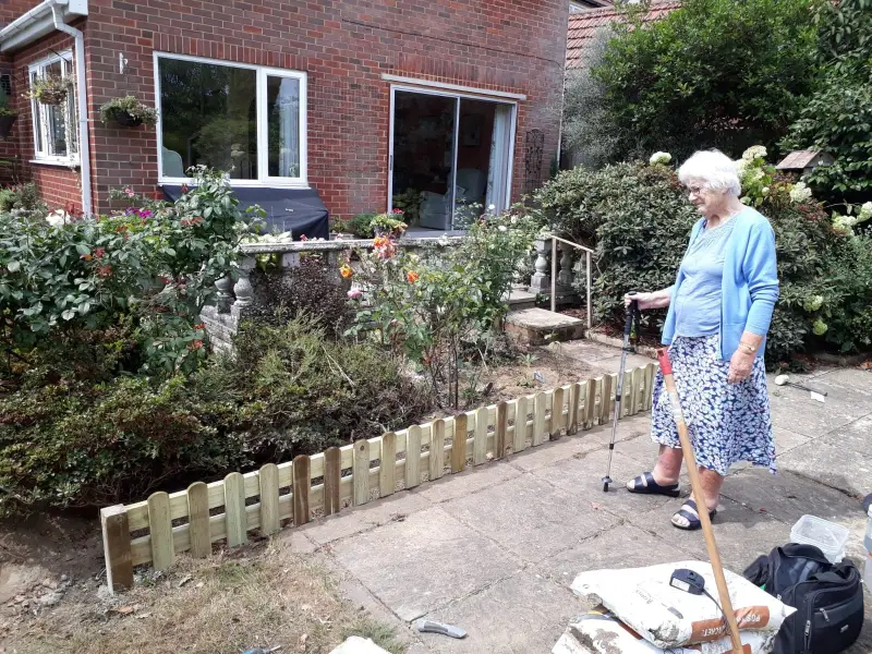 Pat walking in her garden