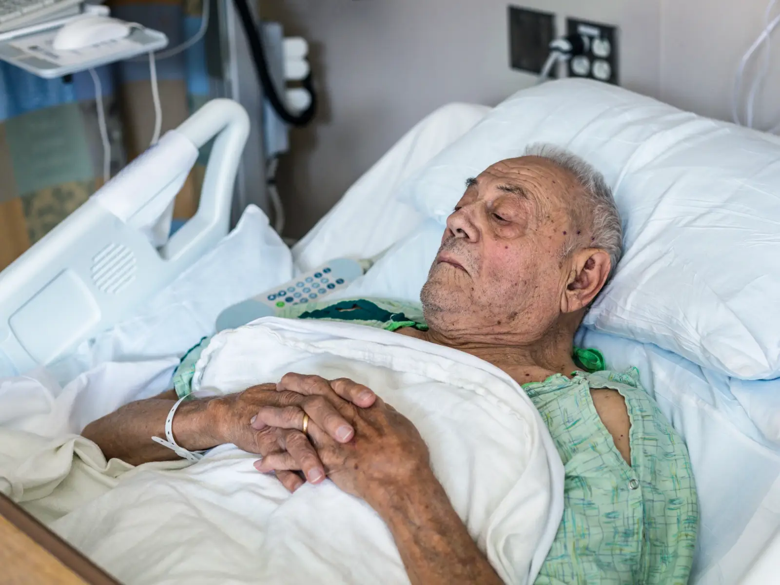 Elderly man in hospital bed