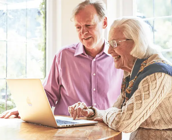 Two people using a laptop
