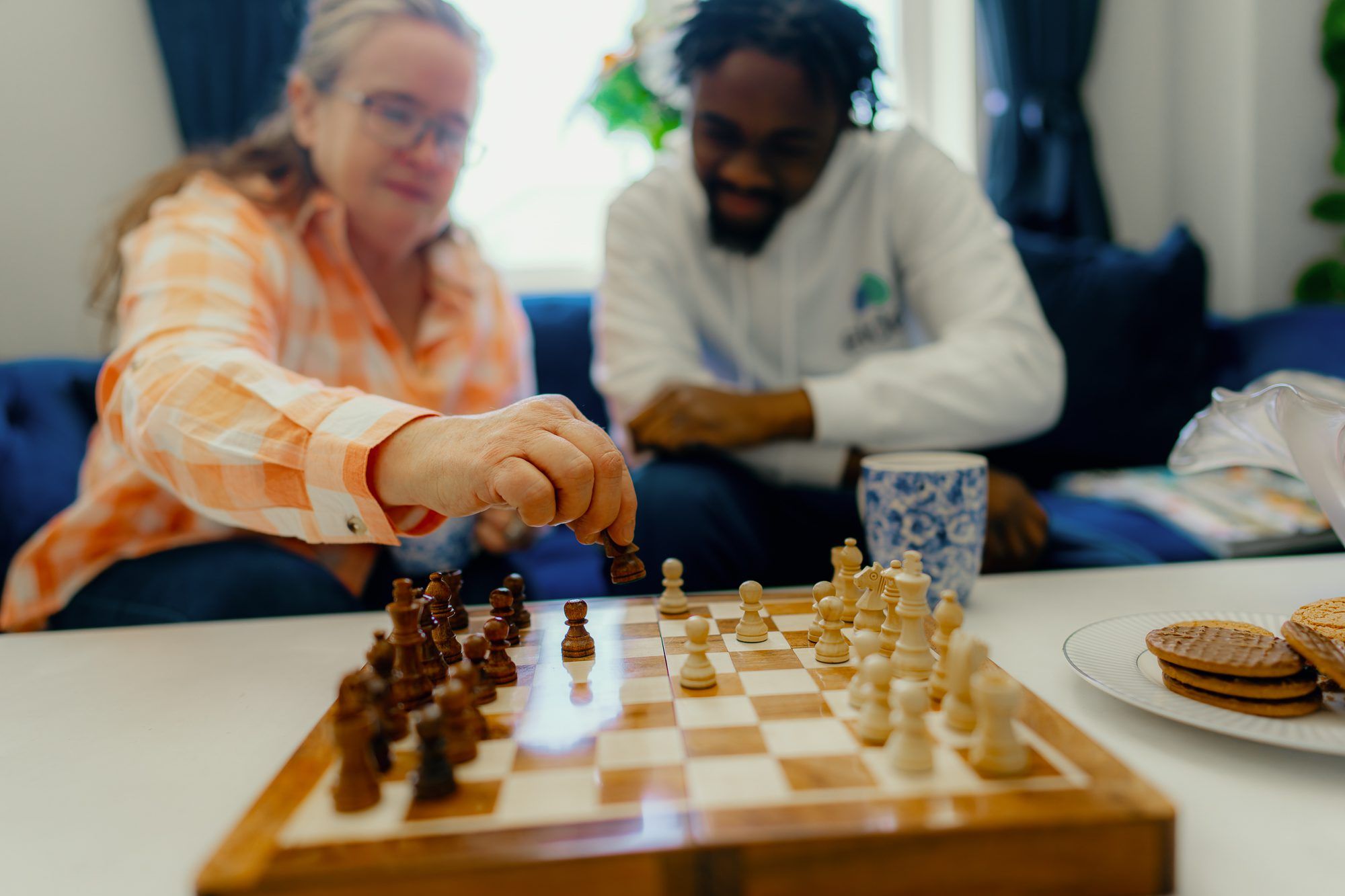 Person with COPD and carer playing chess
