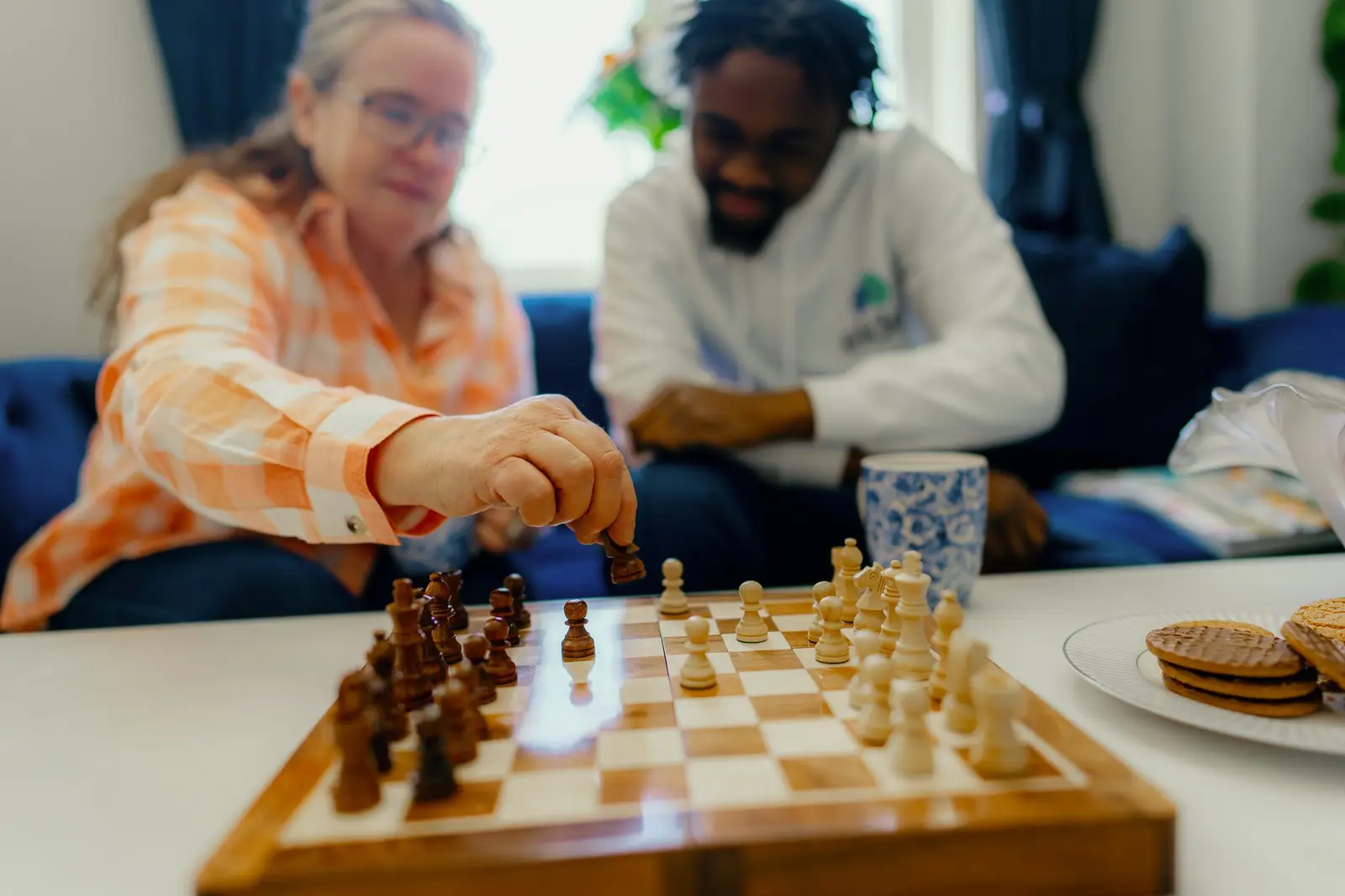 Person with COPD and carer playing chess