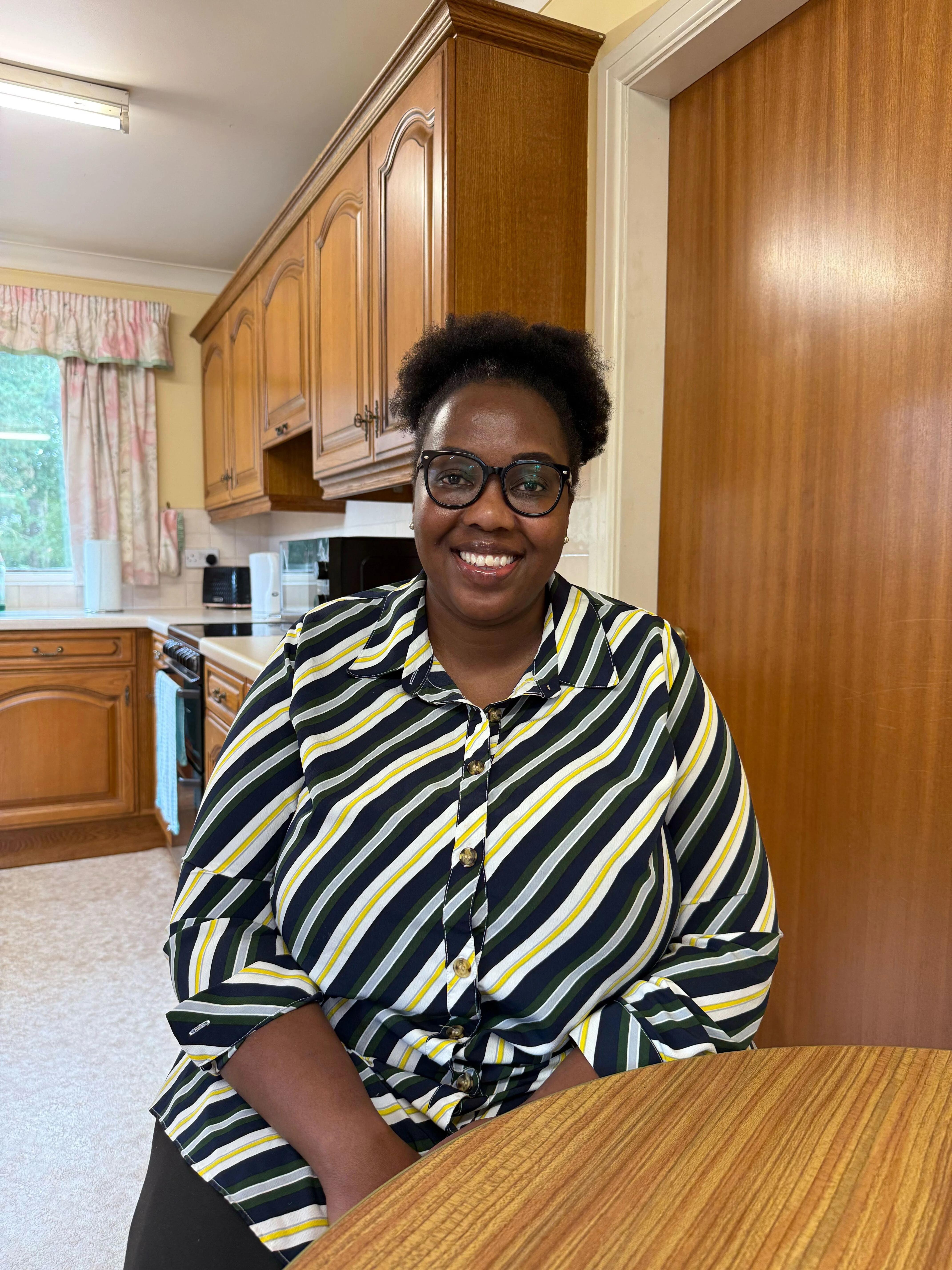 One of our carers, Susan, sitting in the kitchen
