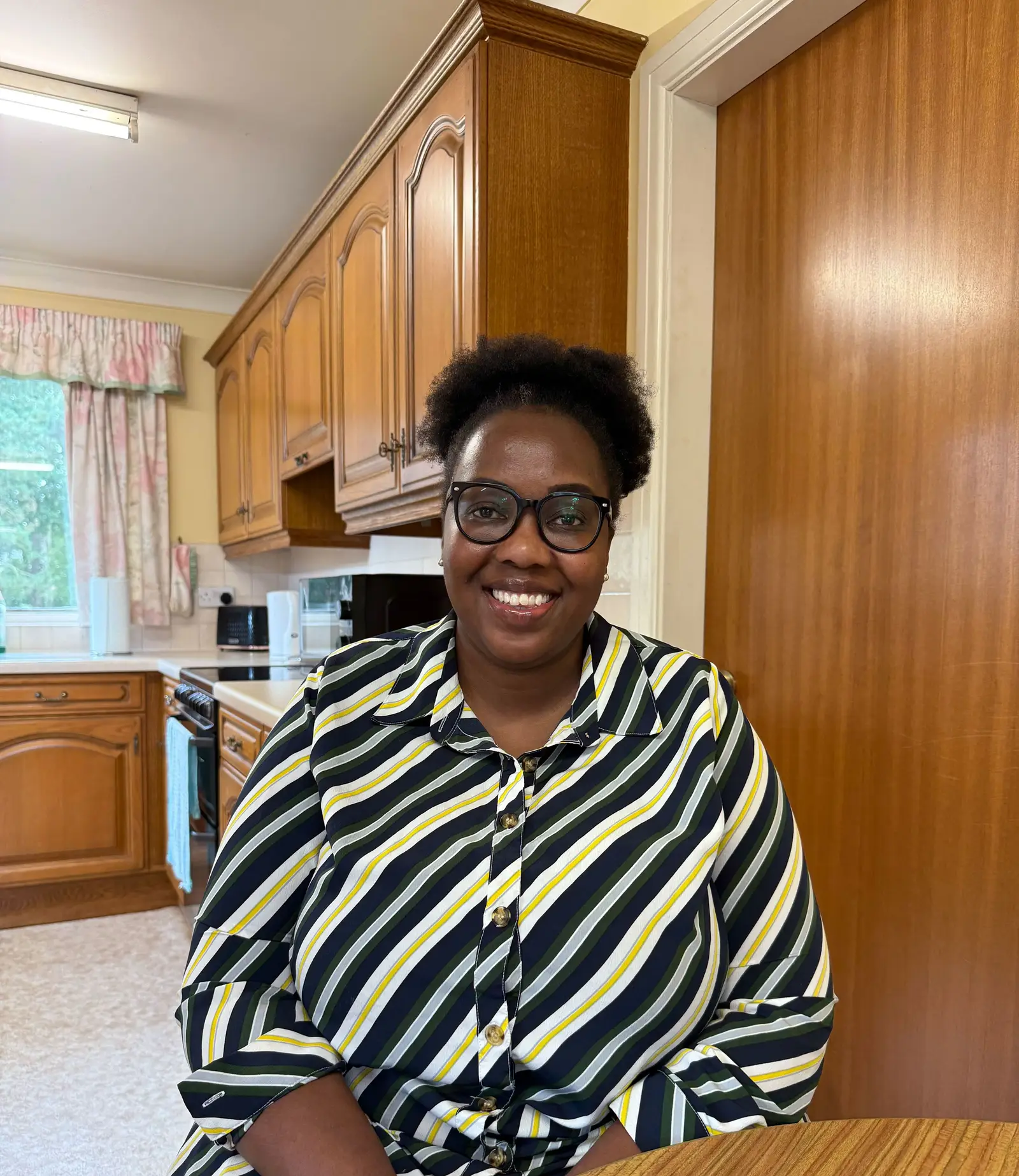 Carer Susan sitting in the kitchen