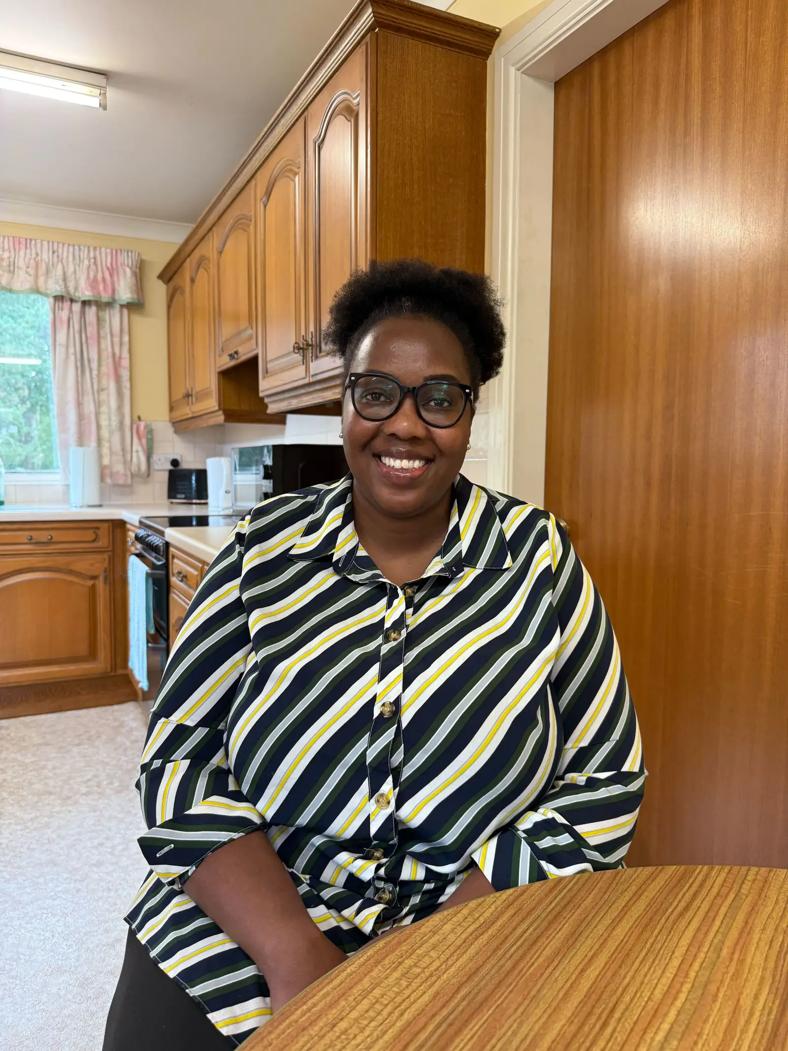 One of our carers, Susan, sitting in the kitchen