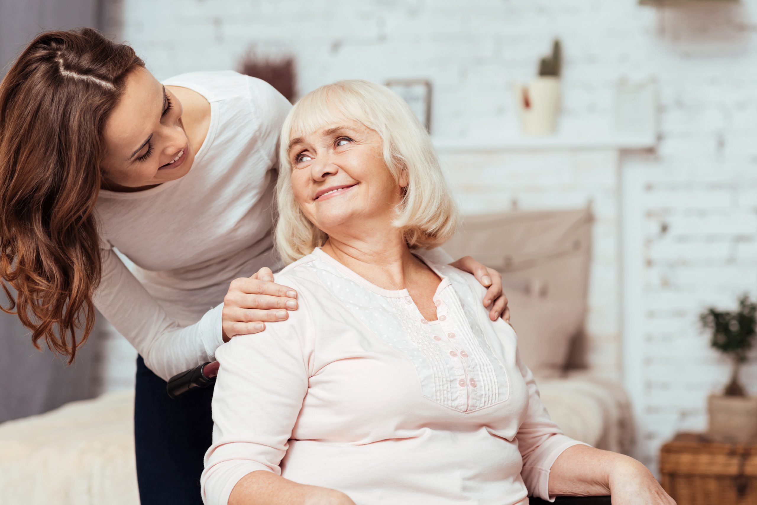 Elderly woman with her carer at home