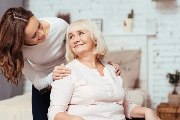 Carer helping woman