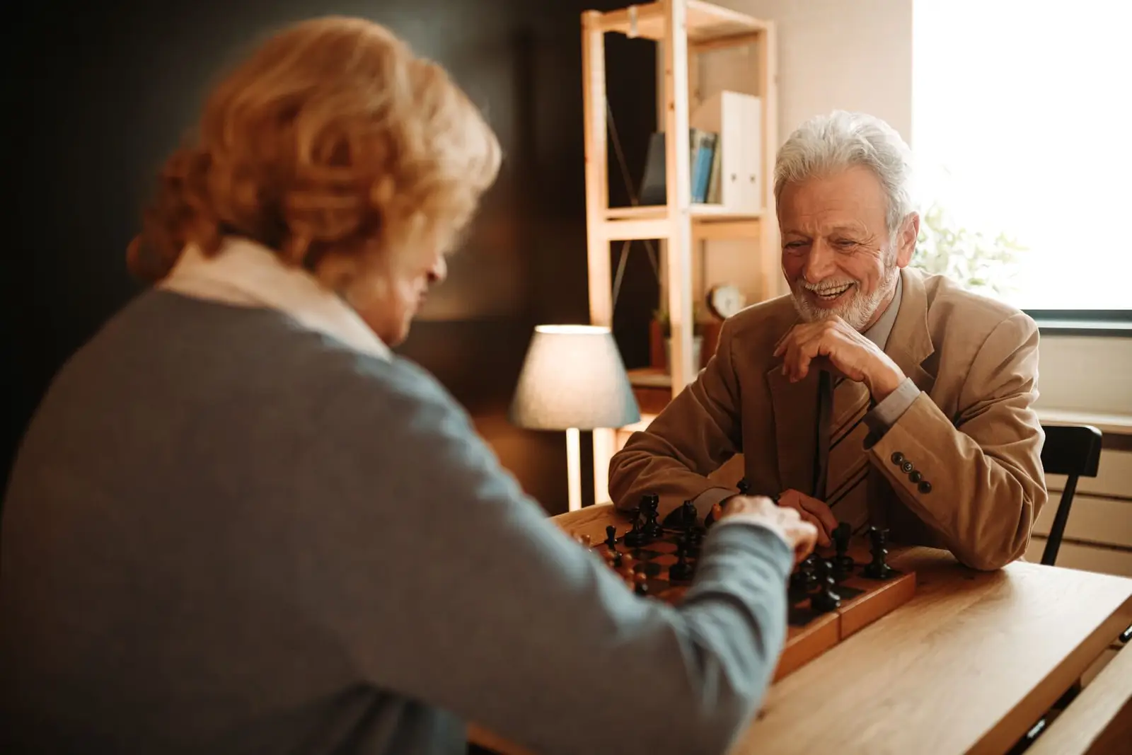 Elderly couple playing chess