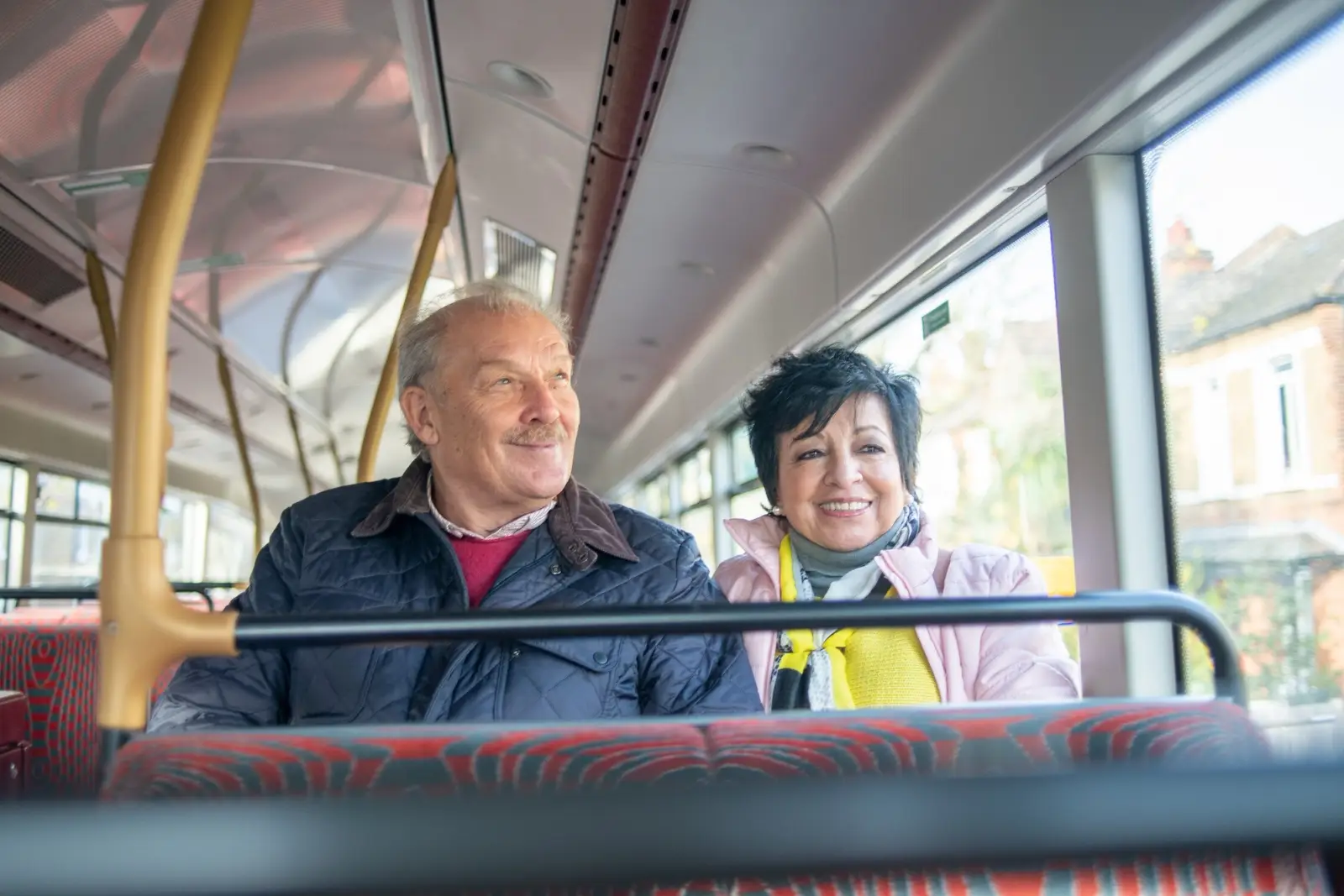 Older man on bus with carer