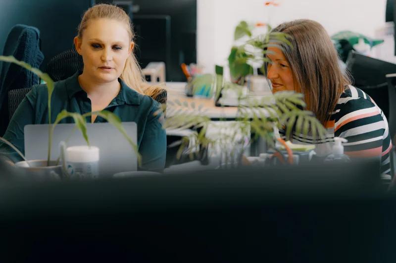 Two woman looking at a laptop
