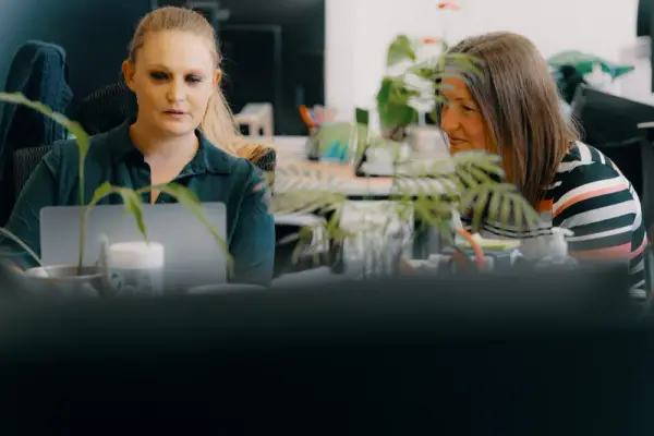 Two woman looking at a laptop