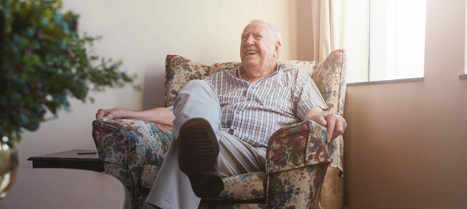 elderly man sitting on armchair