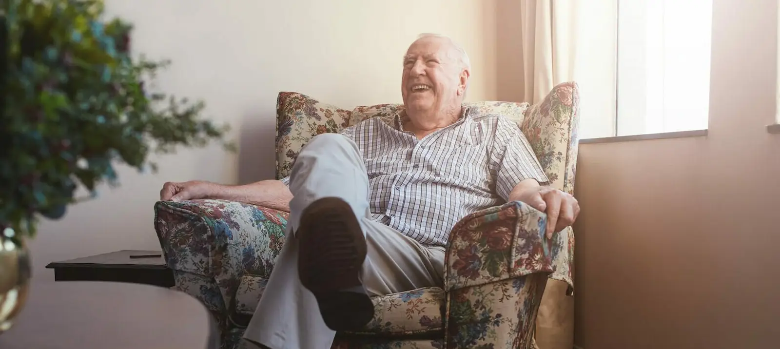 elderly man sitting on armchair