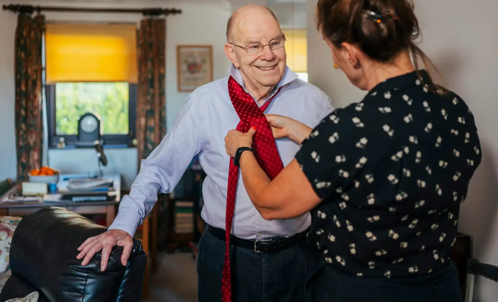 Carer helping elderly man with dressing