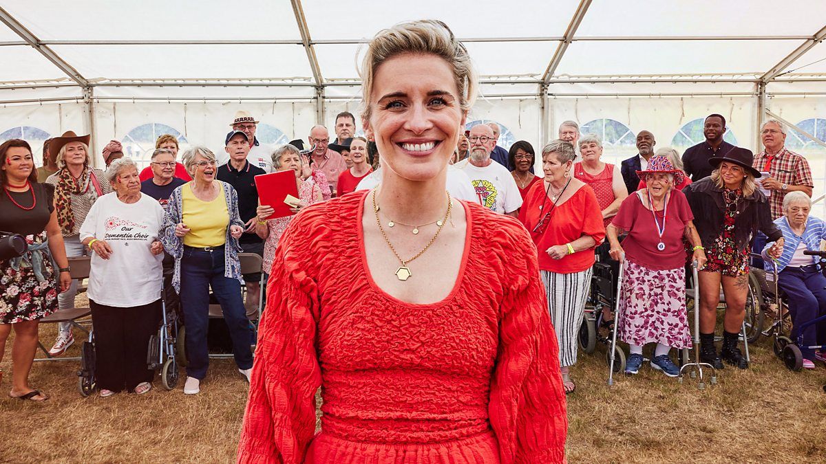 Vicky McClure stands in front of choir members living with dementia in Our Dementia Choir (BBC, 2019)