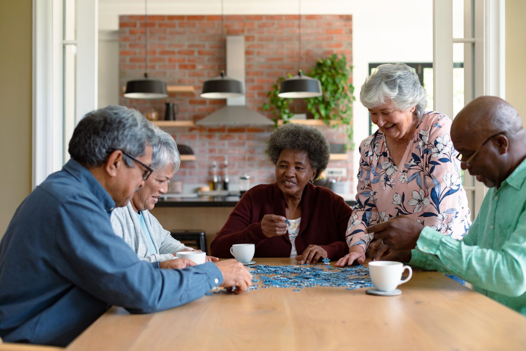 Group of elderly people playing puzzle
