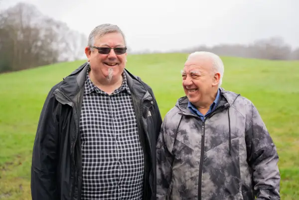 Two men standing in a field