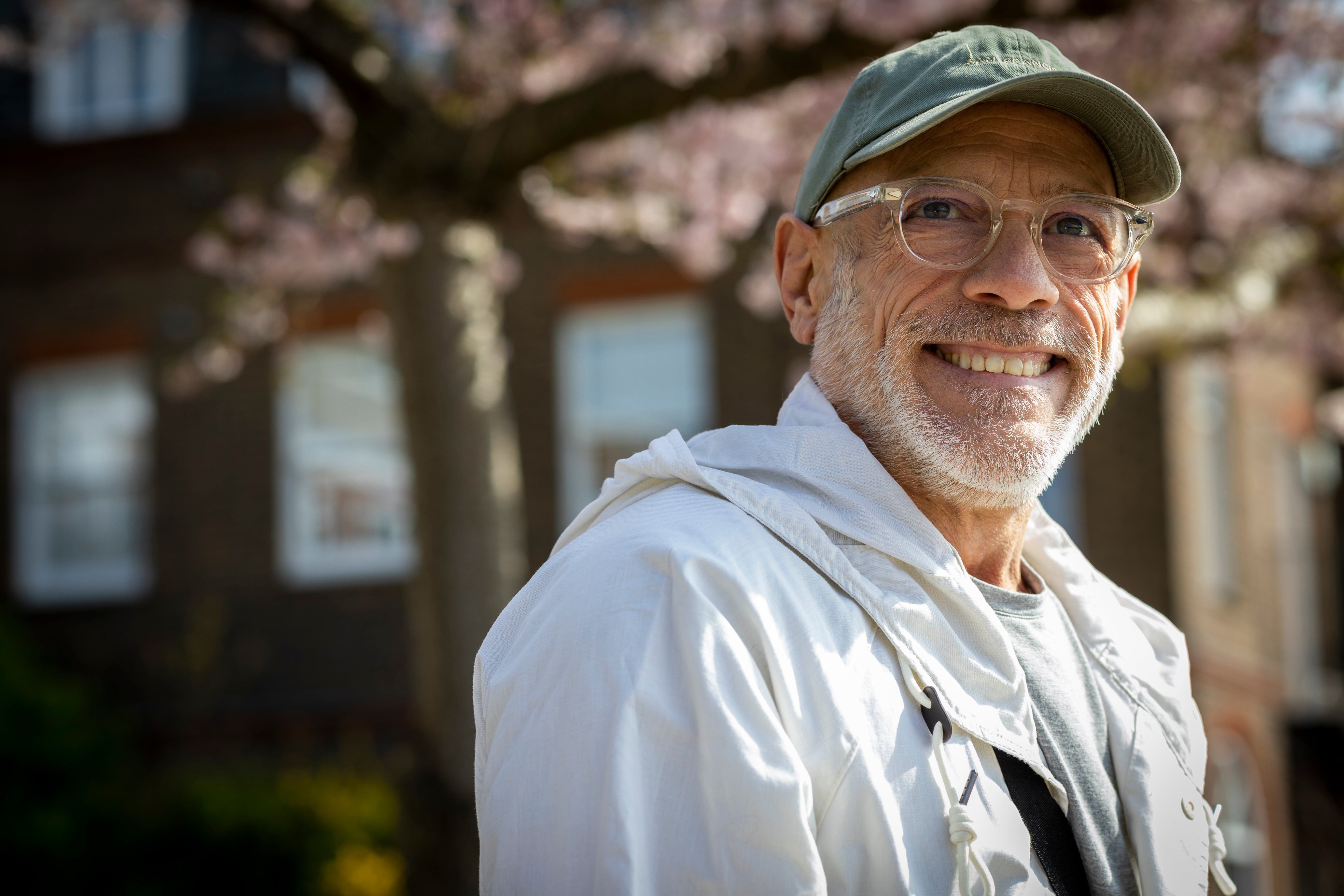 Man in hat and glasses smiling