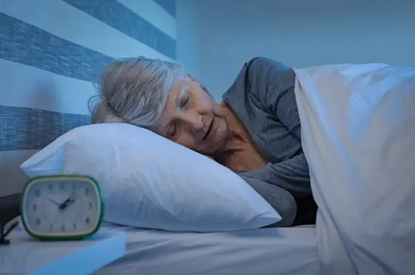 elderly woman sleeping in her bed