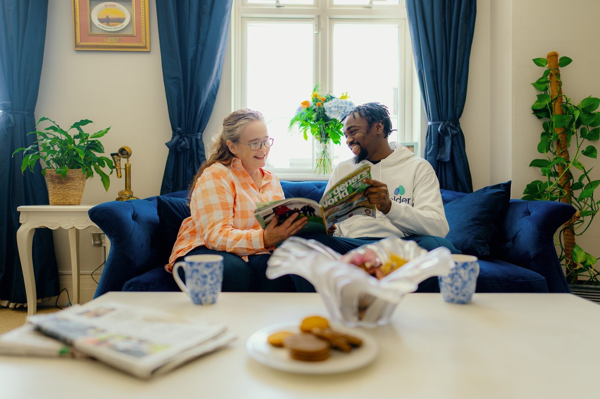 Two people looking at a newspaper