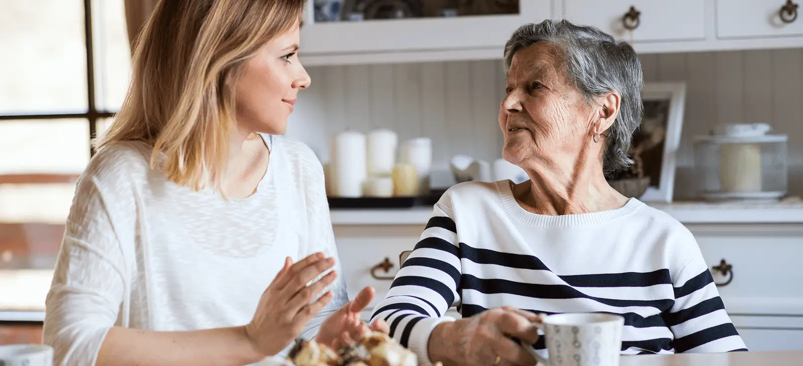 Carer engaging with older woman