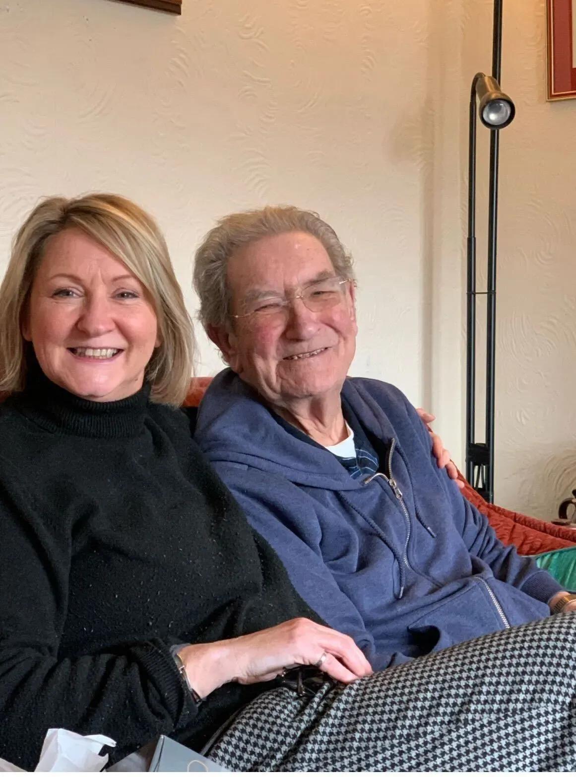 Hayley and her dad Colin sitting on the sofa