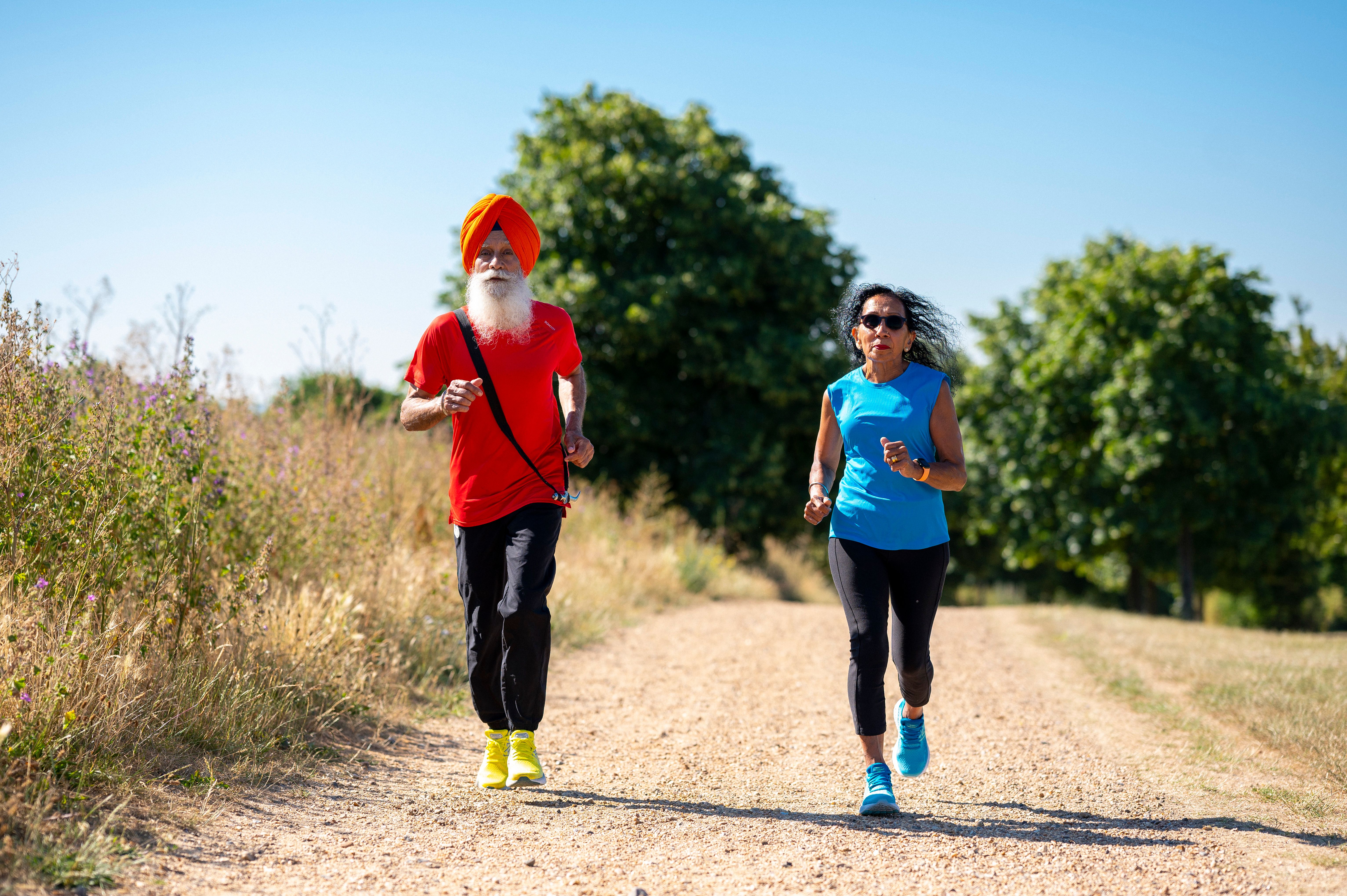 Two elderly people running