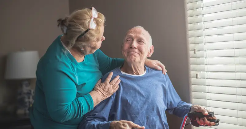 Elderly woman looking at a smiling elderly man