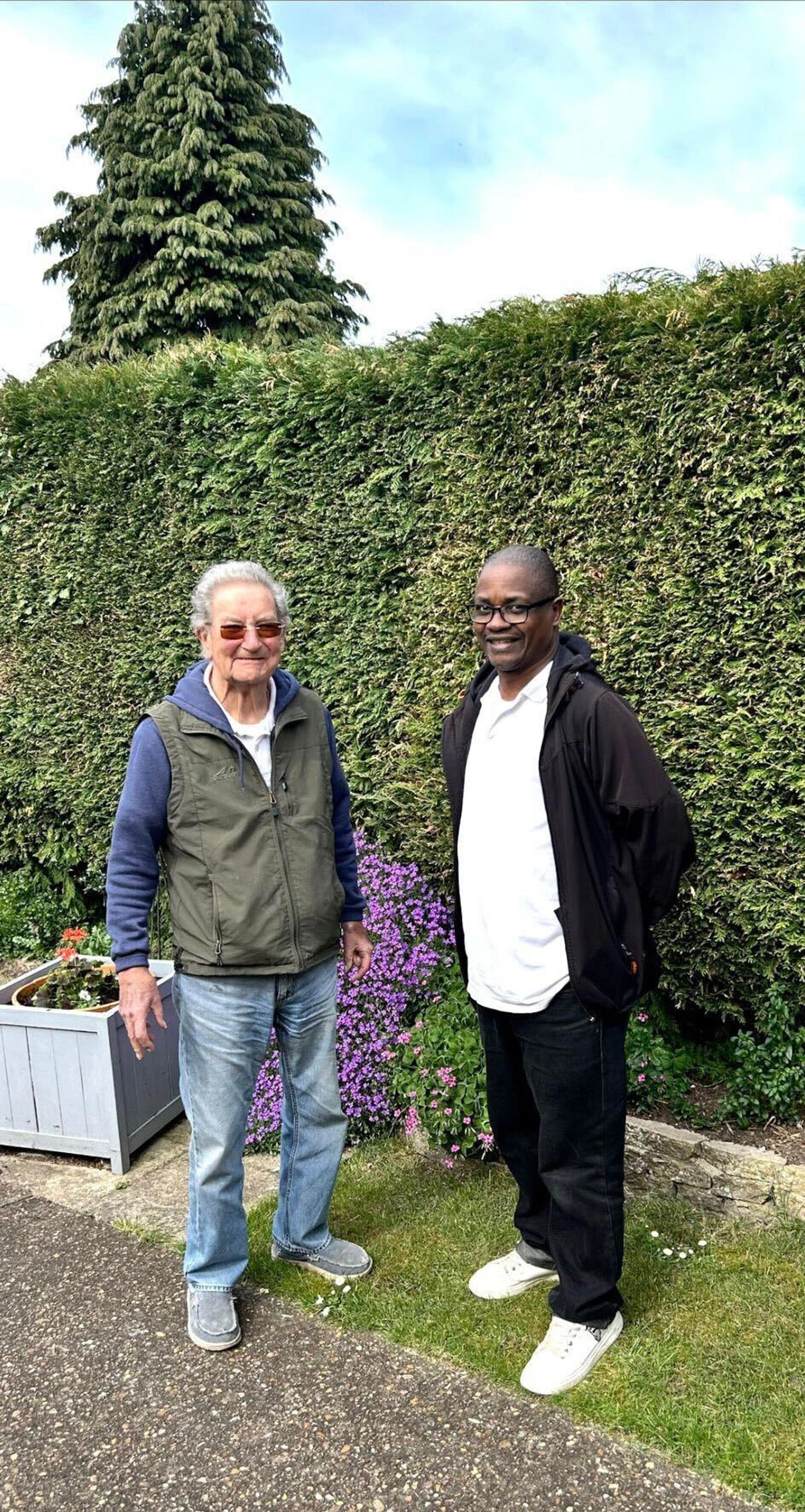 Colin and his carer Norman in the garden