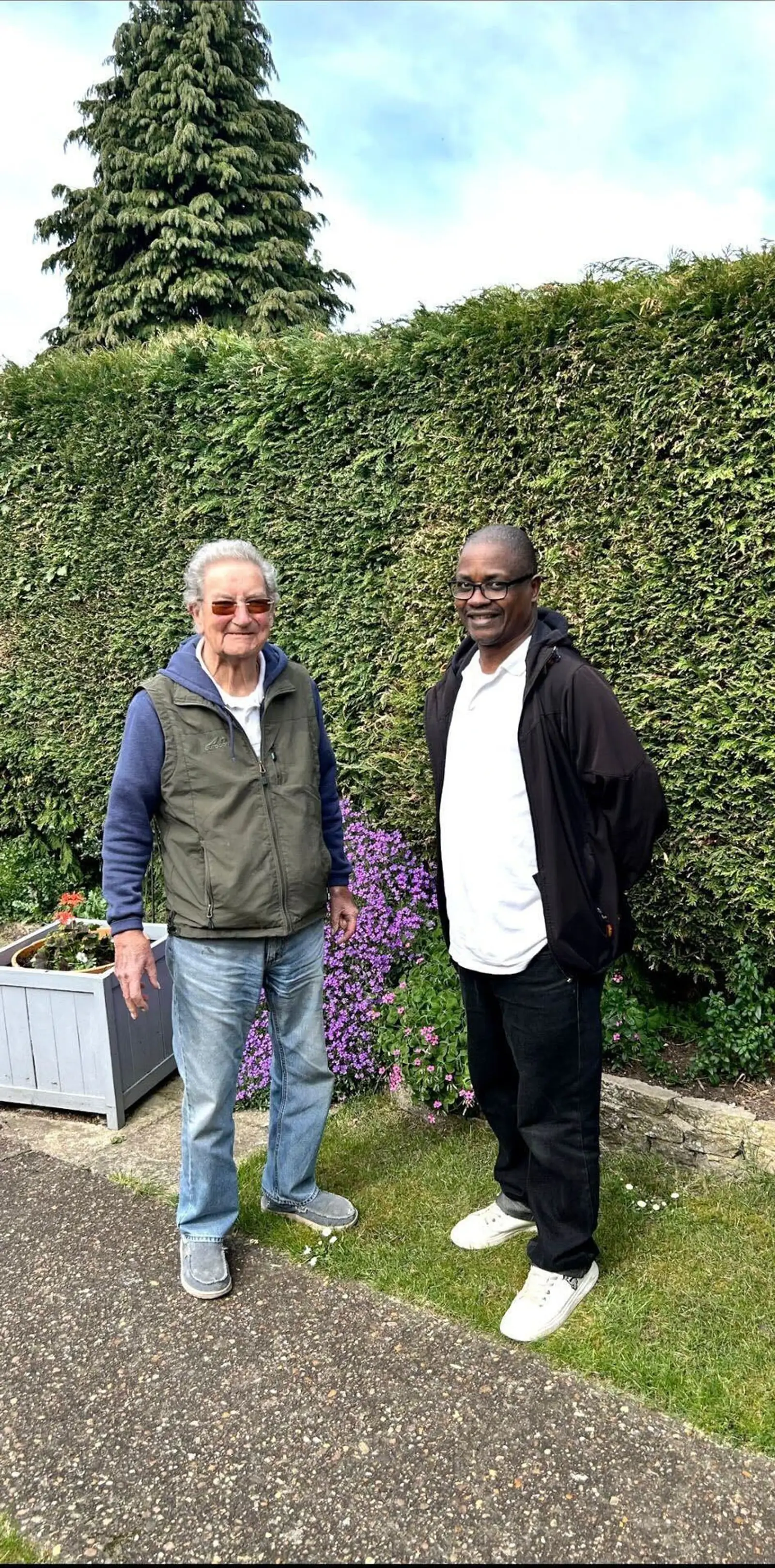 Colin and his carer Norman in the garden