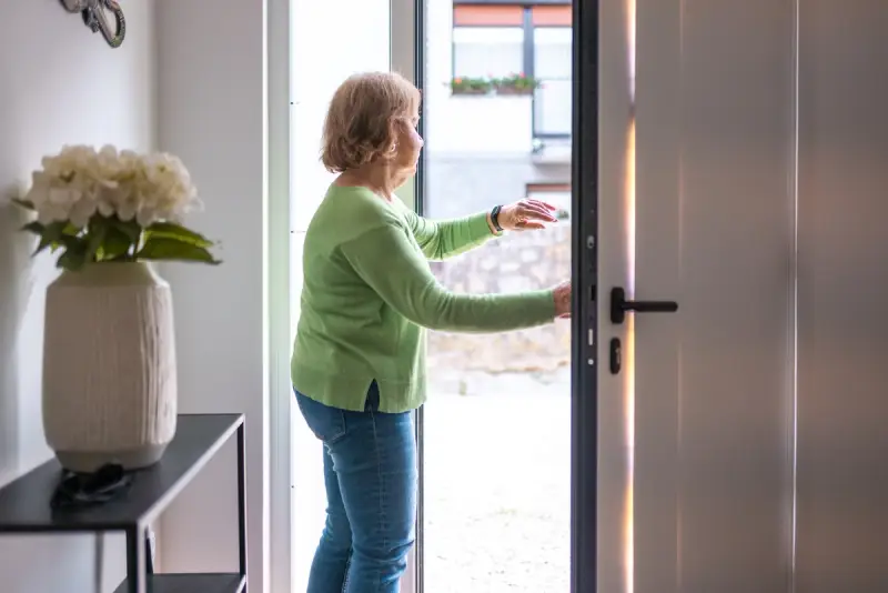 Older woman opening the door