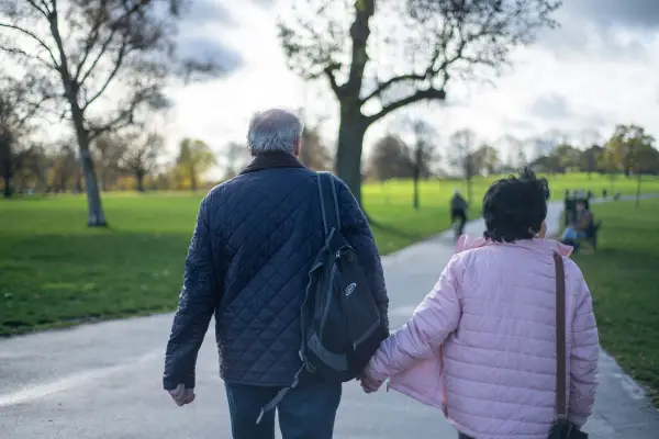 Elderly couple holding hands in a park