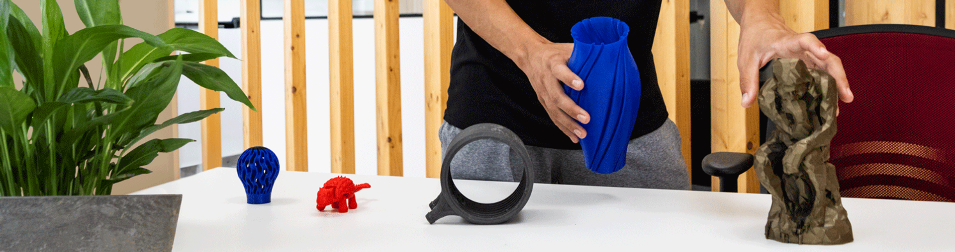 A worker arranging 3D printed pieces