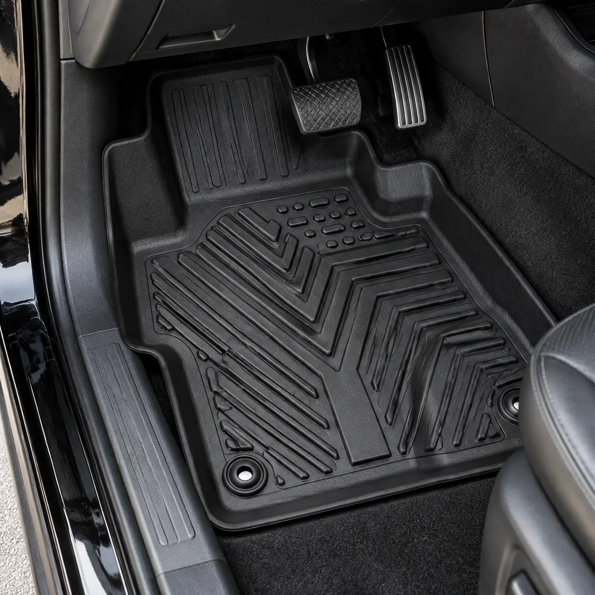 Black rubber floor mat fitted in a car footwell