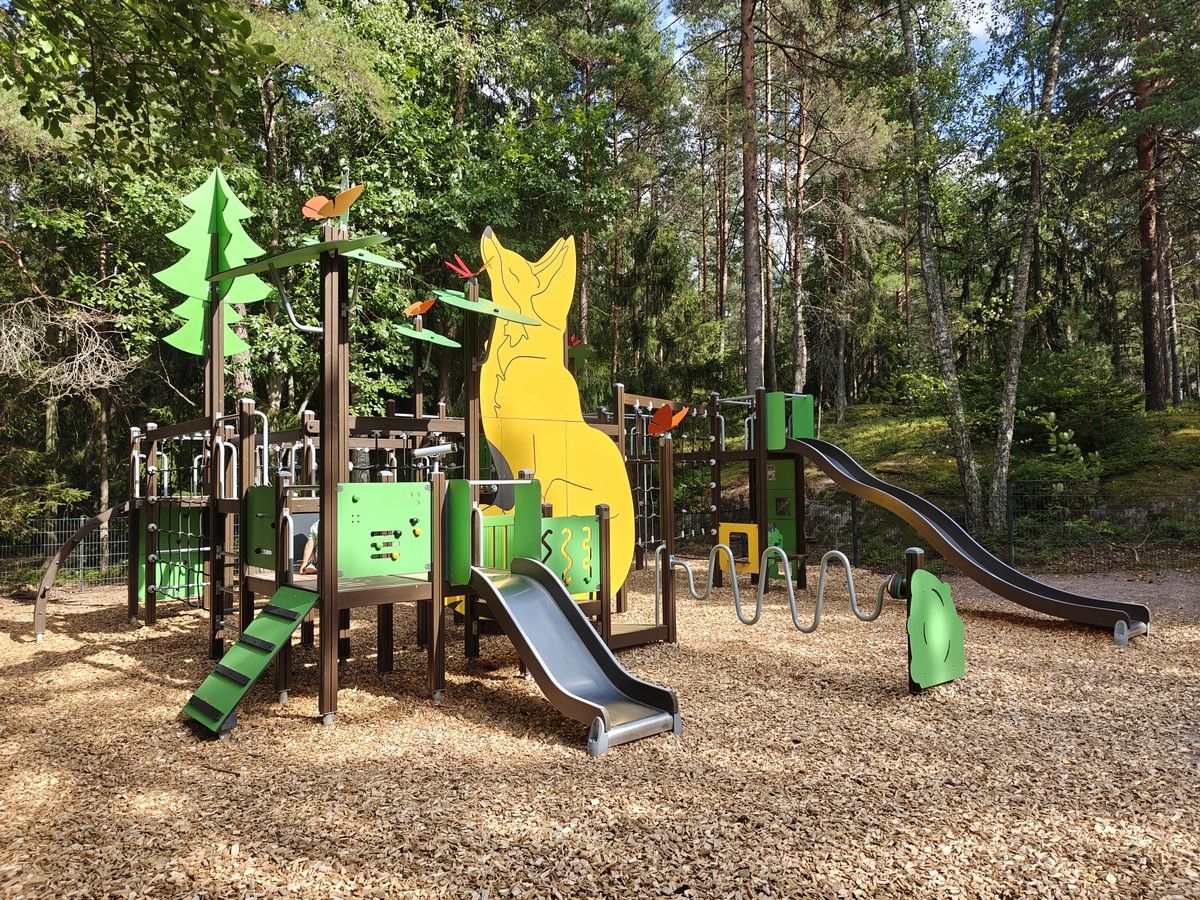 Suuri kiipeilyteline, jossa paljon kiipeiltävää ja kaksi liukumäkeä.