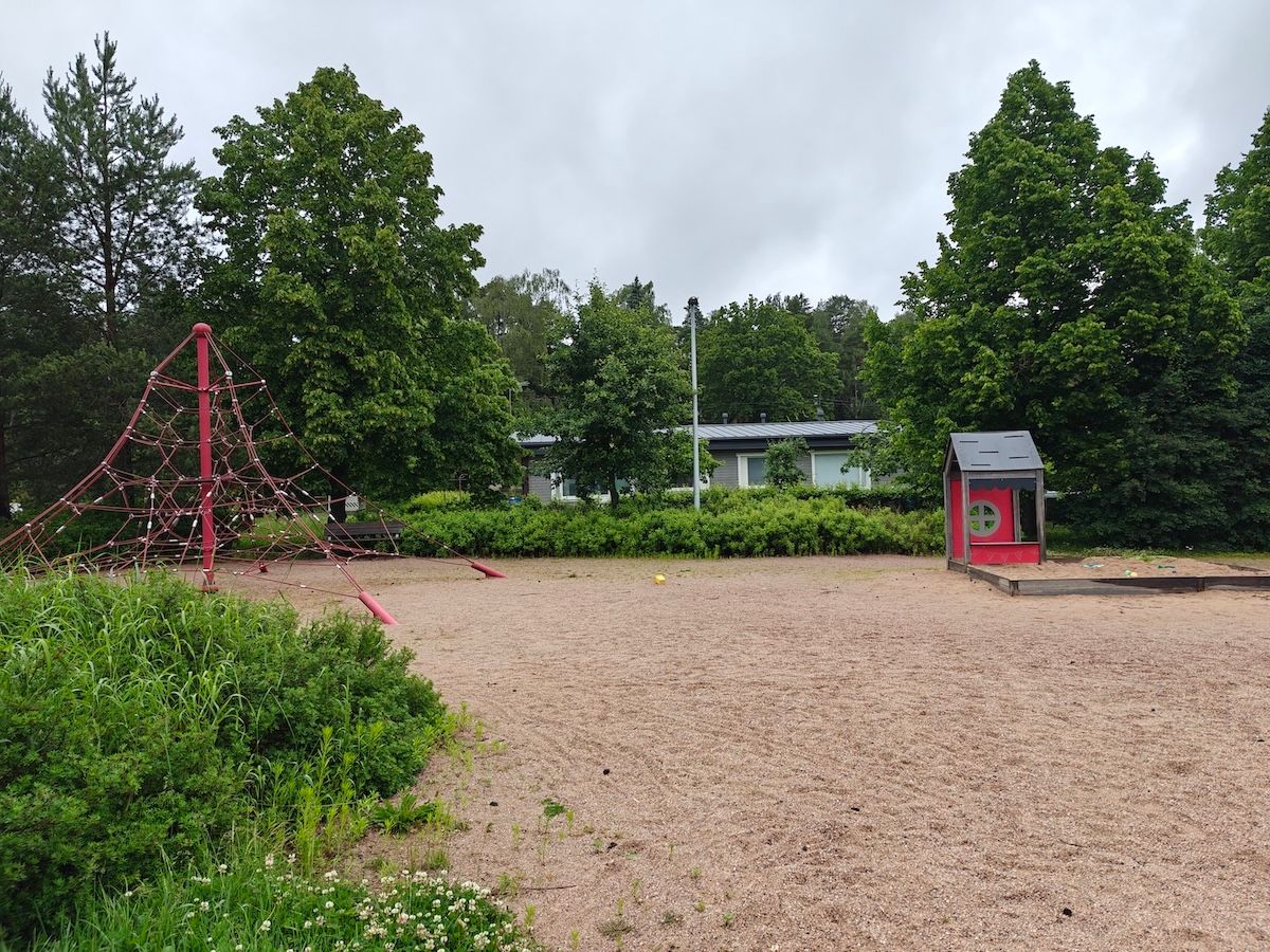 Verkkomainen kiipeilyteline ja hiekkalaatikko.