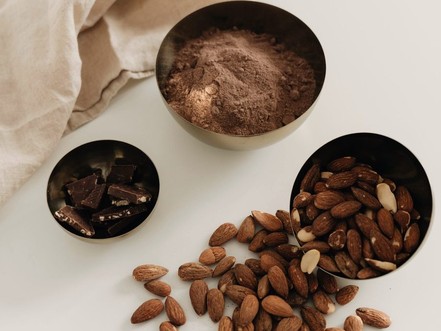 Almonds and cocoa in small bowls, ready for formulation
