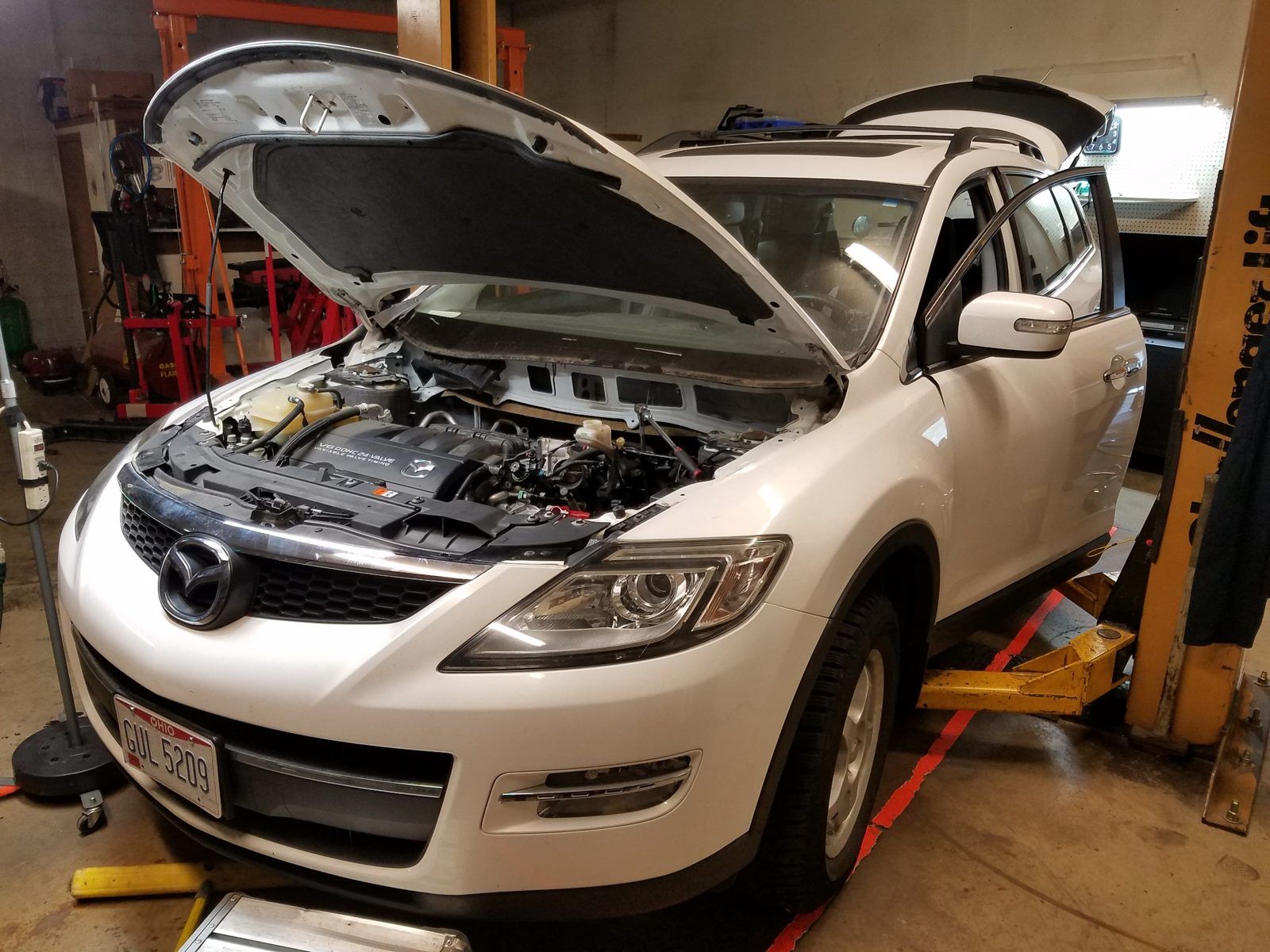 Mazda CX-9 raised on the lift with the hood open for underhood diagnostics at Speedy Underhood Service in Columbus, Ohio