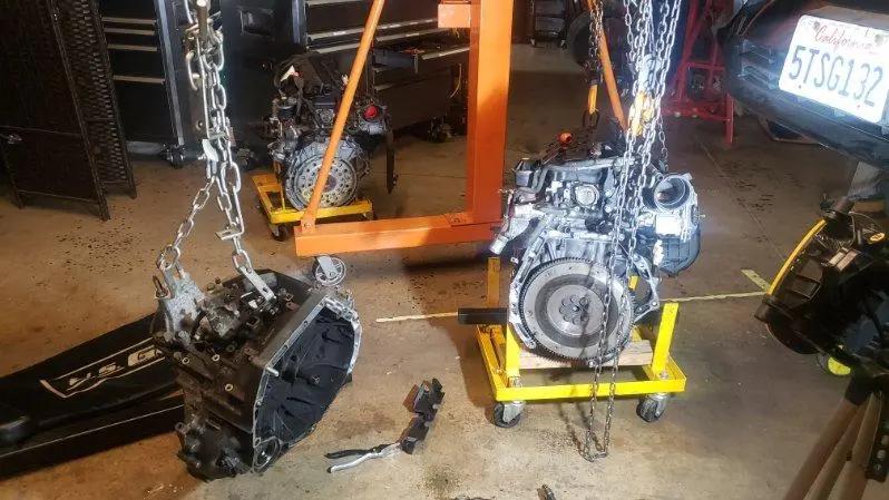 Engine and manual transmission separated on shop stands during a transmission replacement at Speedy Underhood Service in Columbus, Ohio