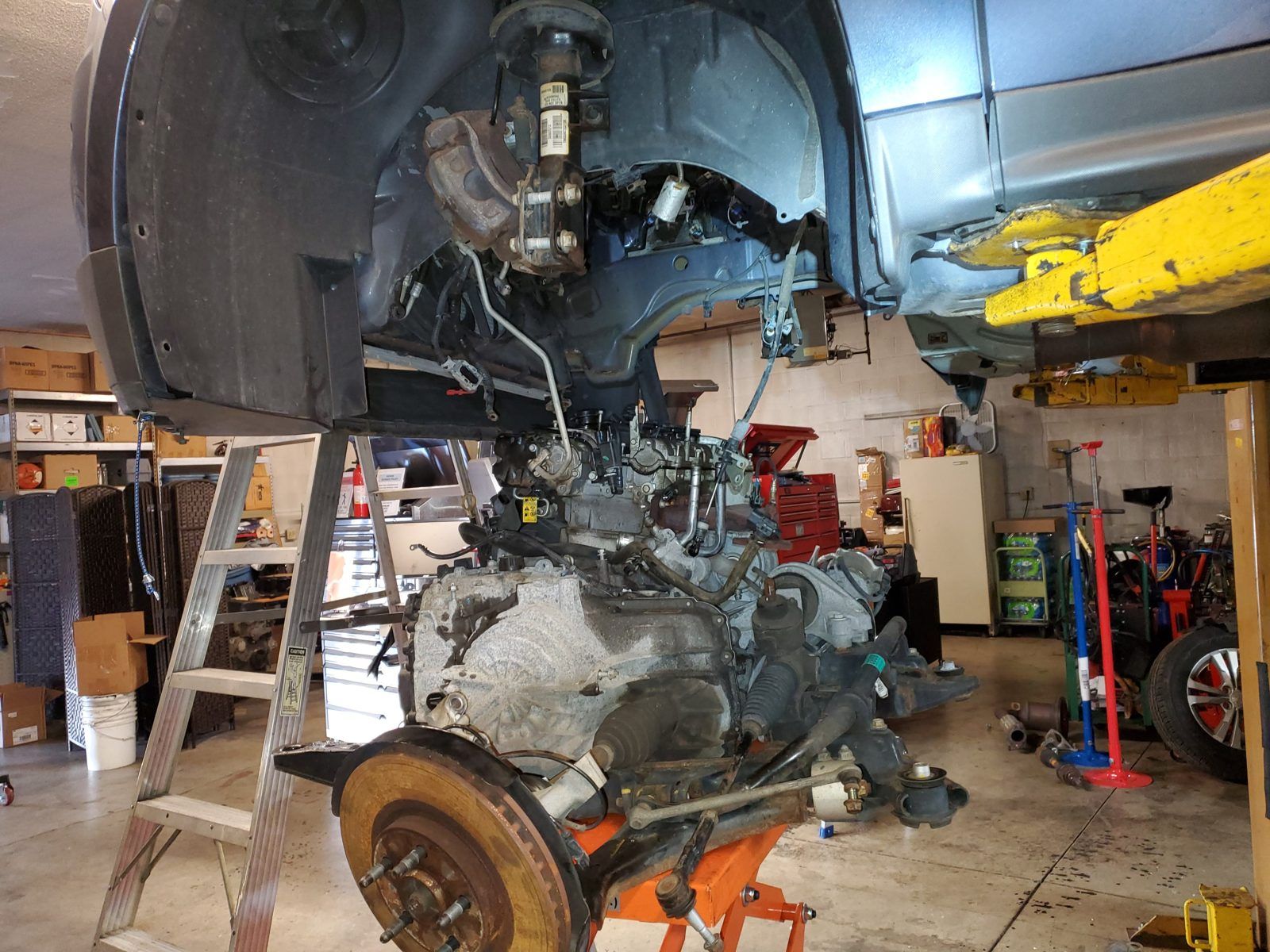 Engine, subframe and axles lowered out of a vehicle as a complete assembly at Speedy Underhood Service in Columbus, Ohio