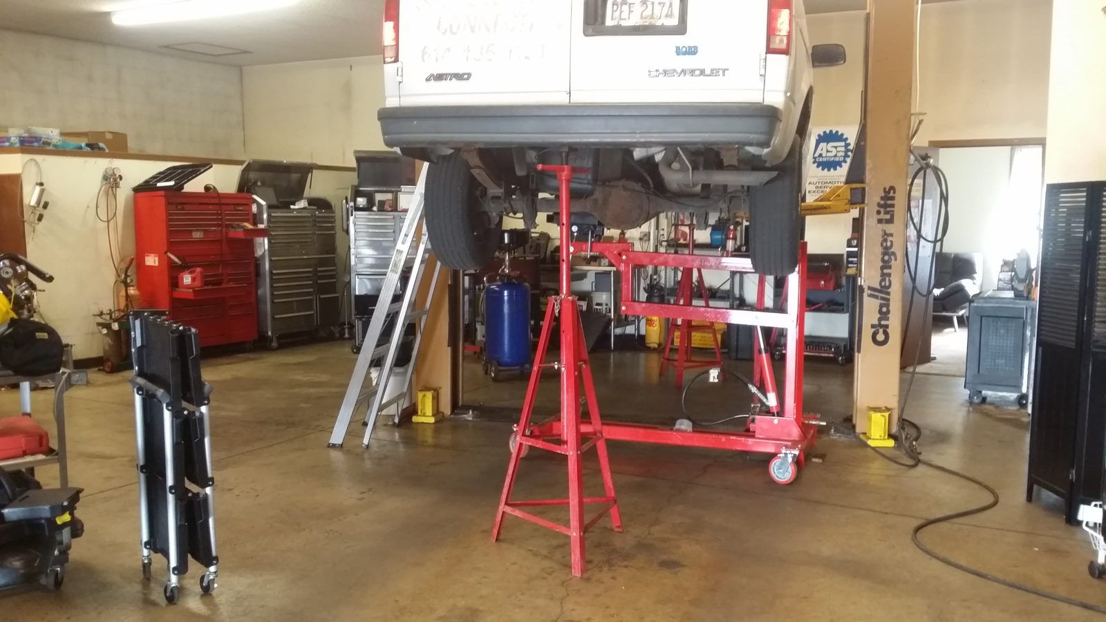 Empty service bays with vehicle lifts, jack stands and rolling tool chests in our Columbus shop at Speedy Underhood Service in Columbus, Ohio