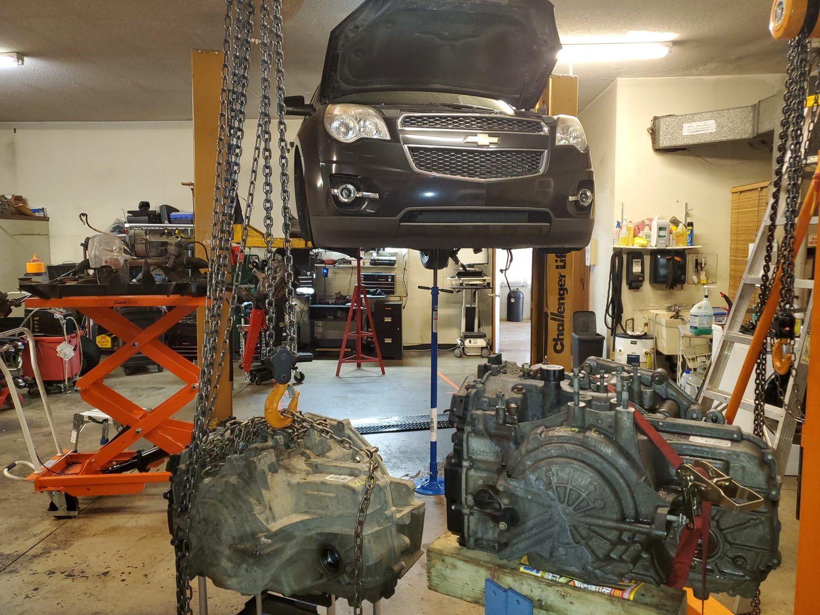 Automatic transmission lowered out of a Chevrolet crossover on the lift at Speedy Underhood Service in Columbus, Ohio