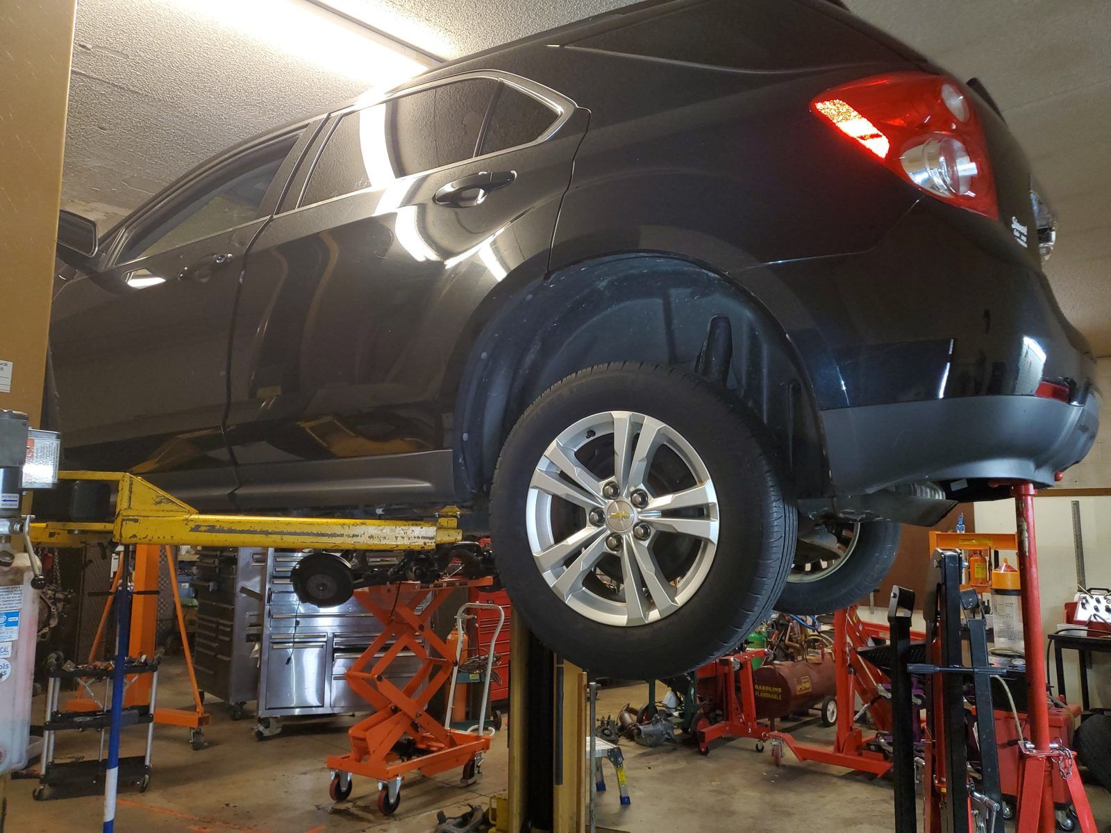 Crossover SUV raised on the two-post lift for undercar inspection at Speedy Underhood Service in Columbus, Ohio