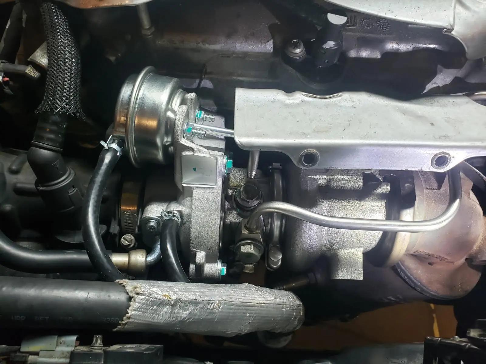 Newly installed turbocharger with oil feed lines on a 2024 Chevrolet engine at Speedy Underhood Service in Columbus, Ohio
