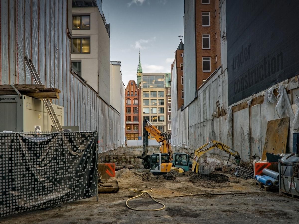 Civil construction site in a city with an excavator in a pit