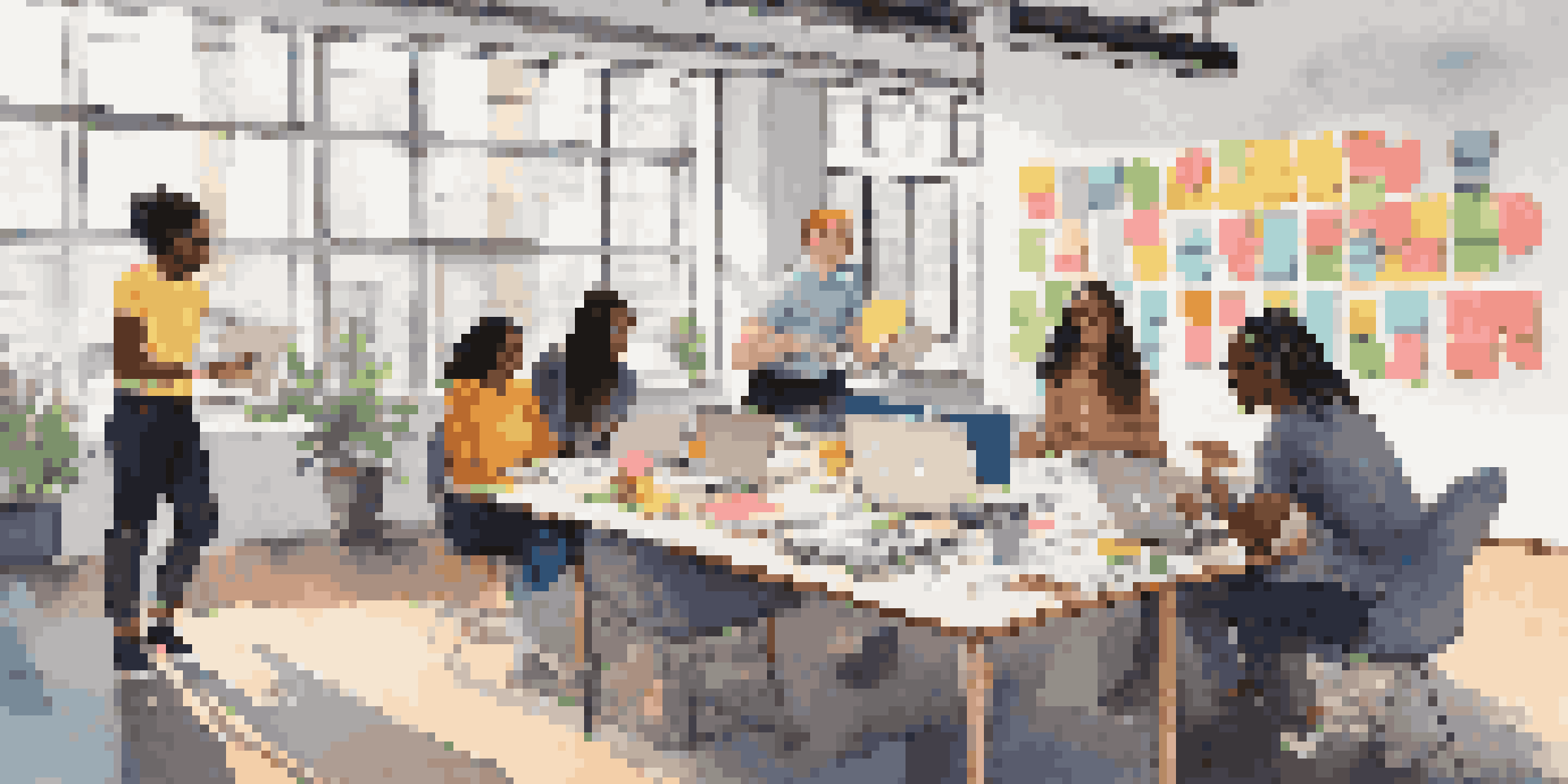 A diverse group of interns collaborating in a bright modern office, engaged in a brainstorming session with laptops and post-it notes.