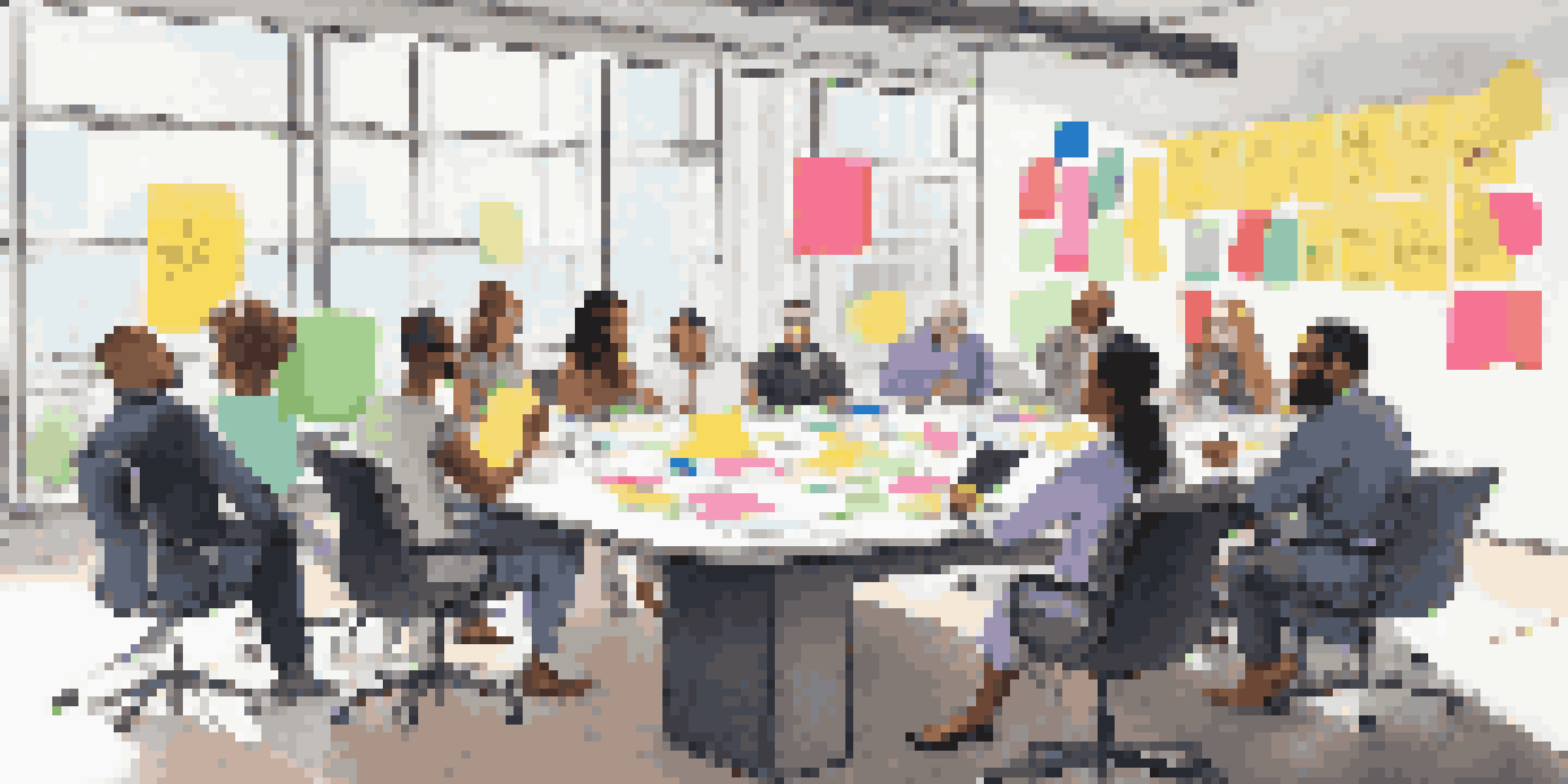 A diverse group of professionals engaged in a brainstorming session at a conference table, with colorful sticky notes around them.