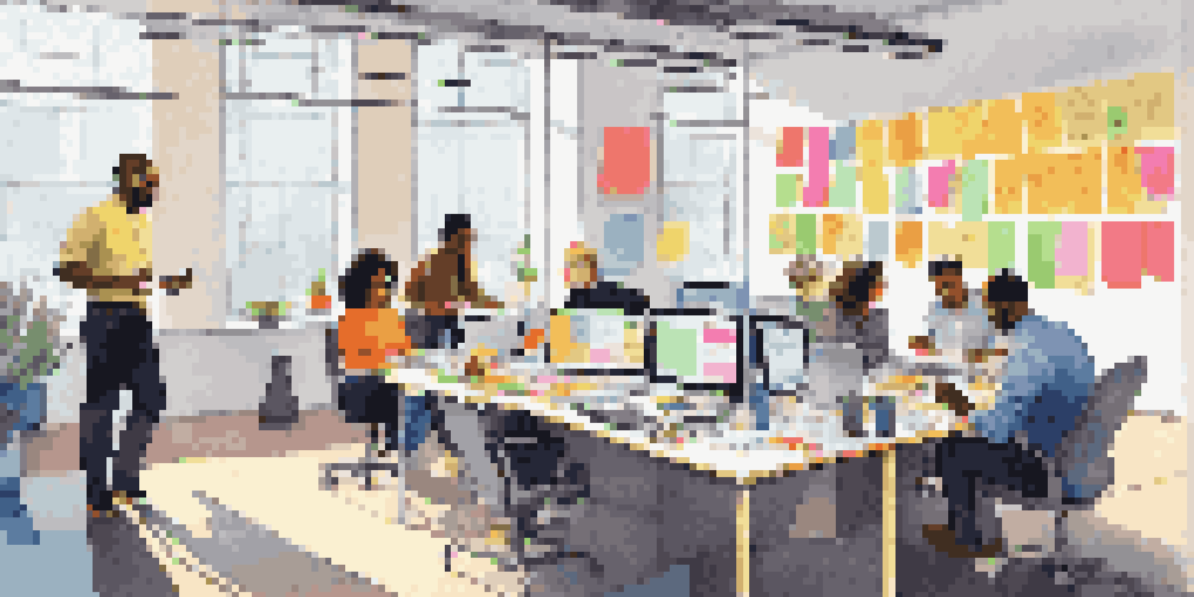 A diverse group of employees brainstorming together in a bright office, surrounded by sticky notes and motivational art.