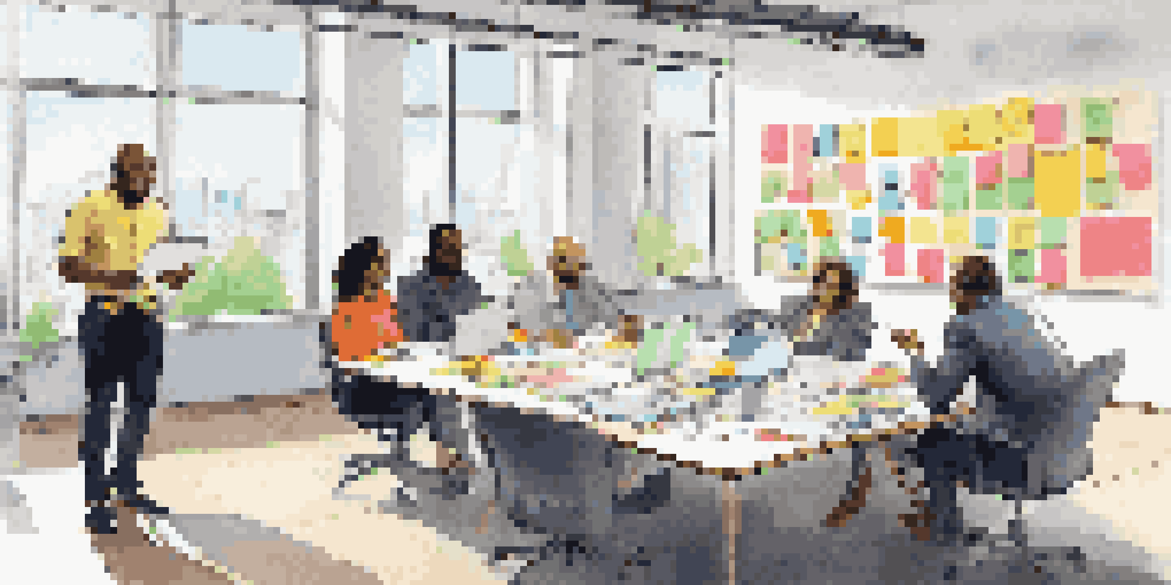 A diverse group of professionals collaborating around a conference table, with sticky notes and laptops, showcasing different personality traits in a well-lit room.