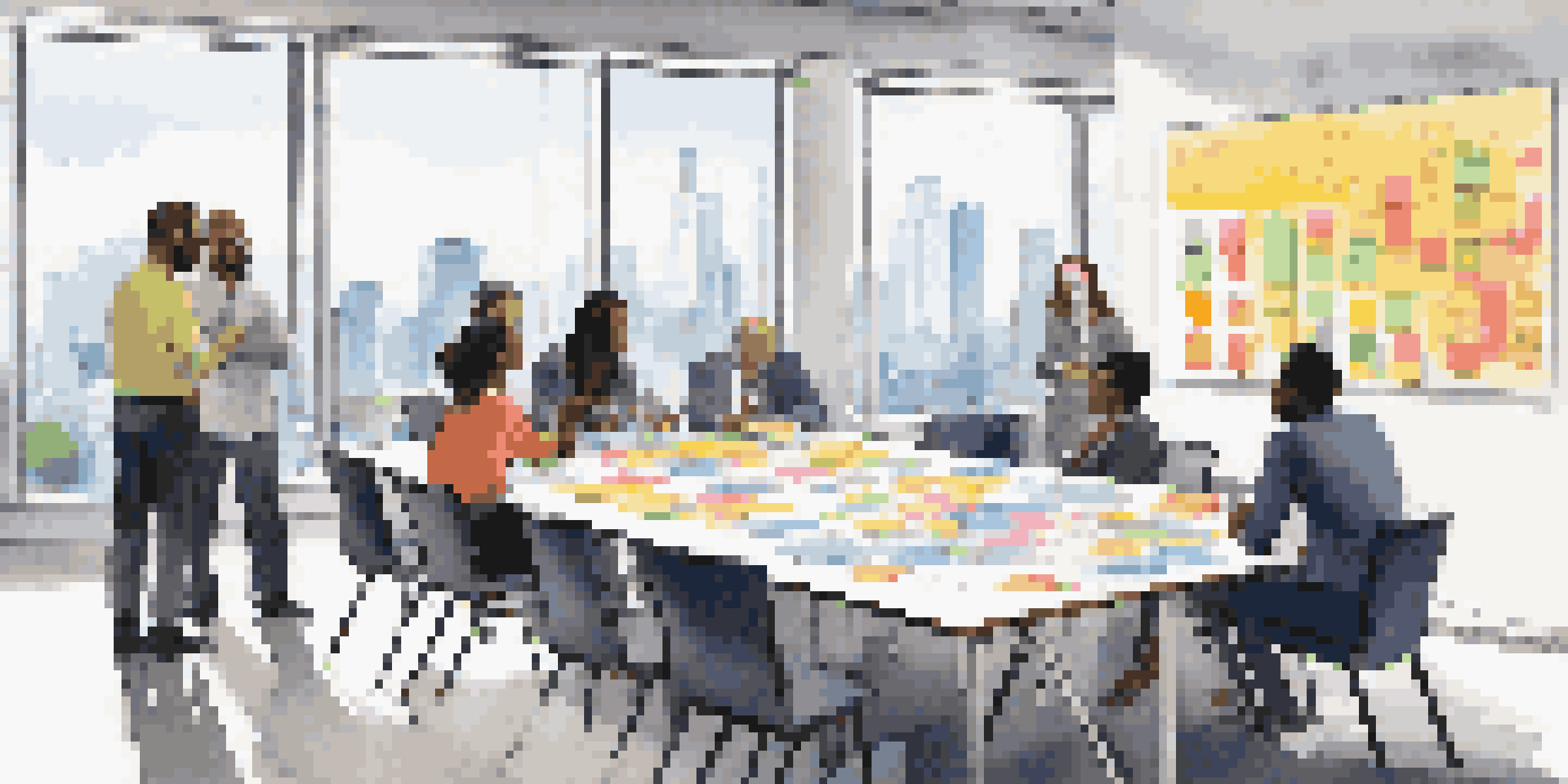A group of diverse professionals collaborating in a bright conference room, sharing ideas and notes.