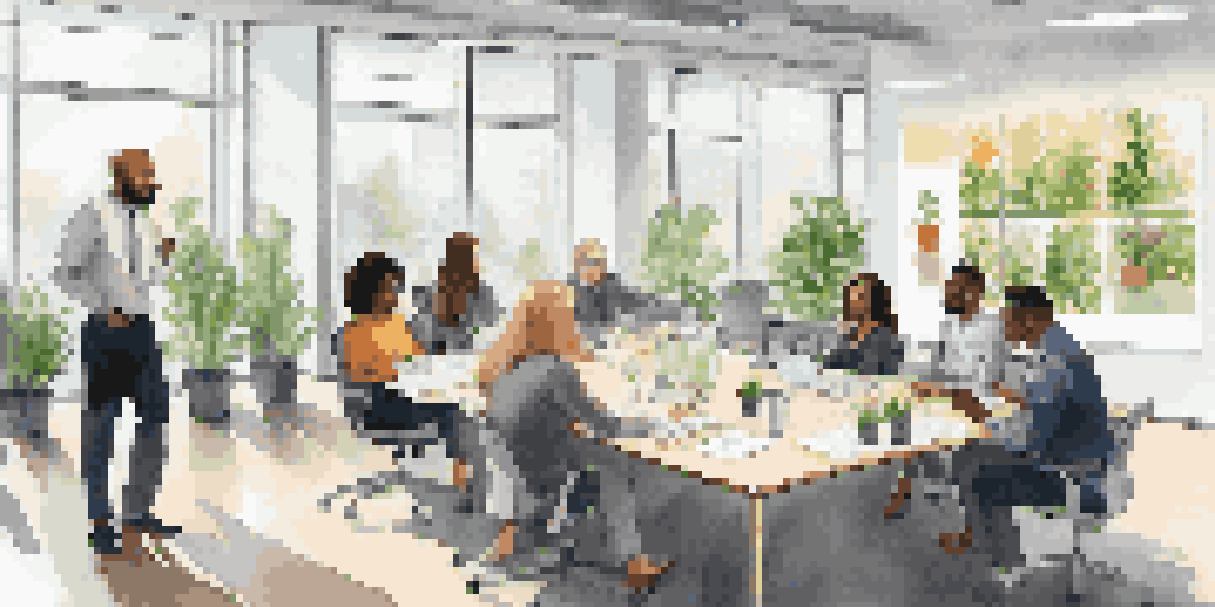 A diverse group of employees having a constructive discussion in a bright office conference room.